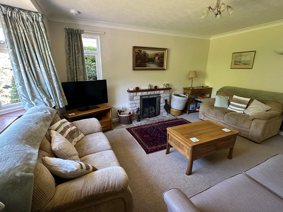 A living room with sofas and a television at Pineside Sandford, Dorset