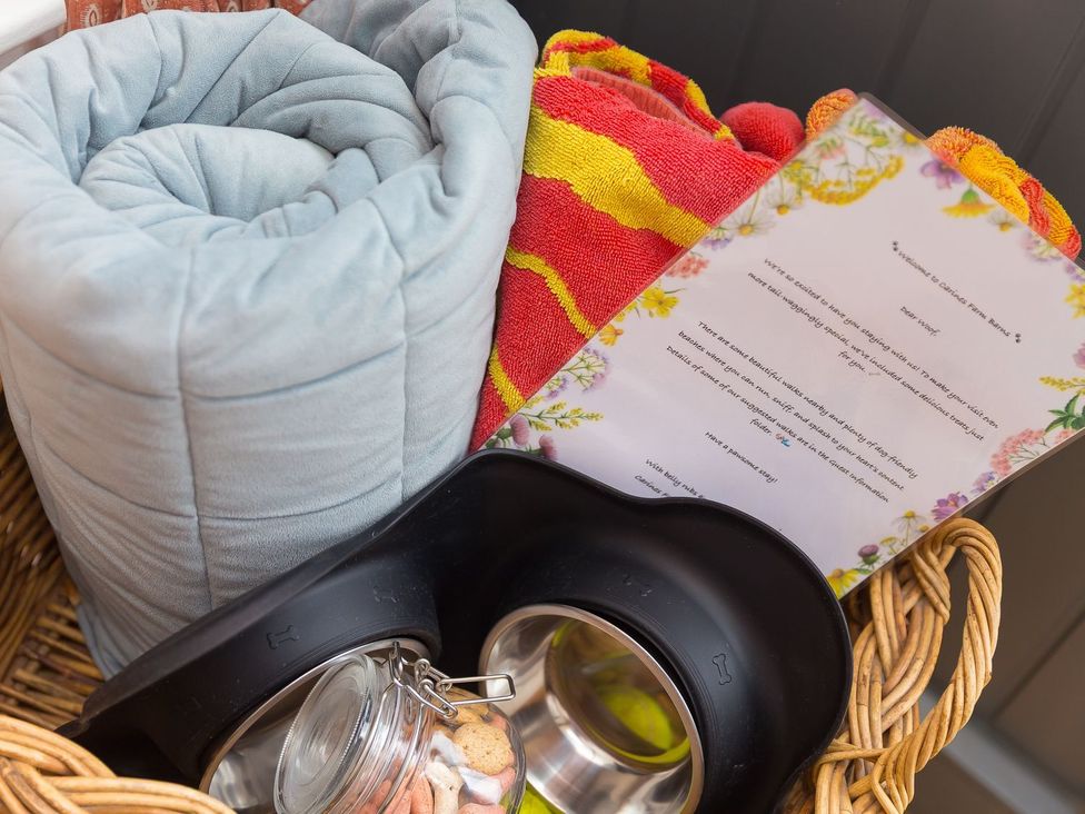 Baskets with towels, slipcovers, note and pet bowls at Carines Barns - Pol, Cubert