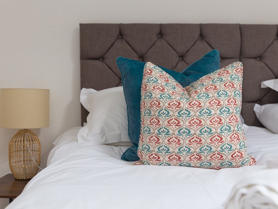 A bedroom with pillows on a bed at Carines Barns - Pen in Cubert