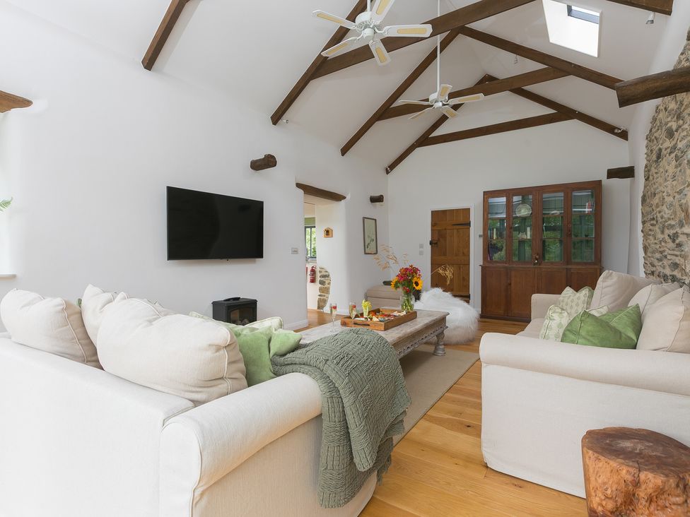 A living room with a sofa and coffee table at Carines Barns - Wesley Barn in Cubert