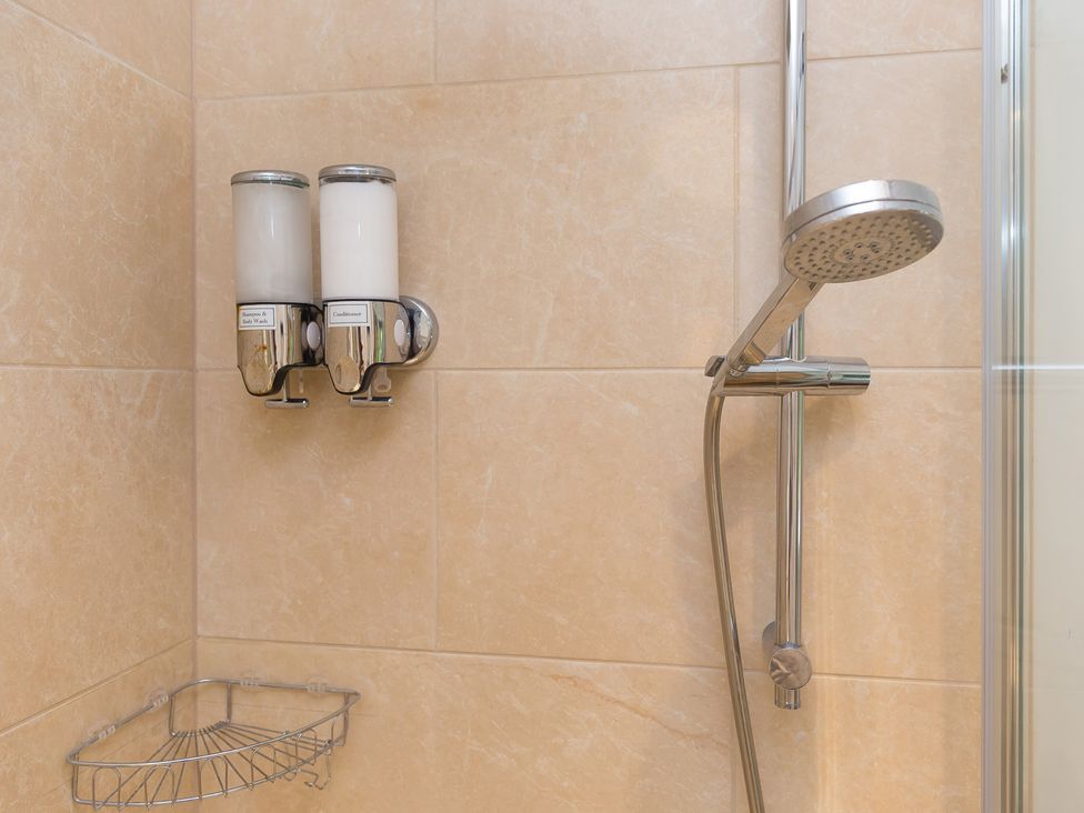 A shower with shampoo and conditioner dispensers at Carines Barns - Wesley Barn, Cubert