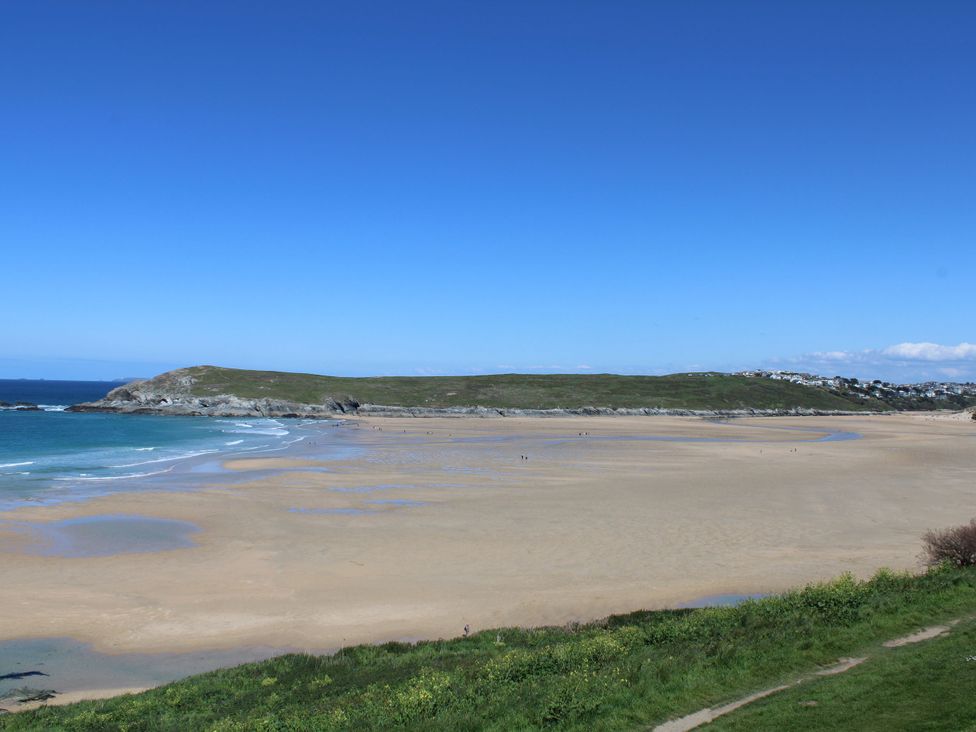 A beach with sand and water at Carines Barns - Wesley Barn, Cubert