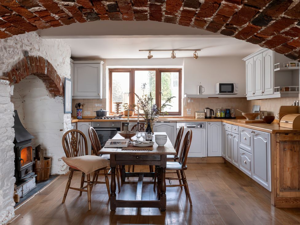 A kitchen with a table and chairs at Lower Mill in Dittisham