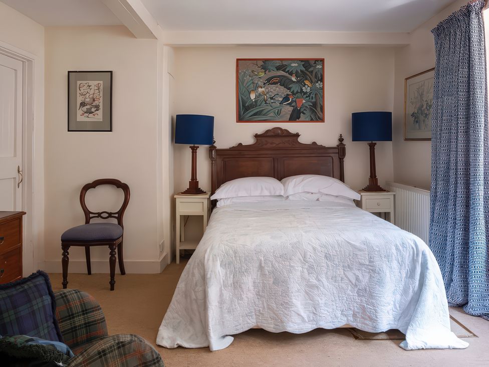 A bedroom with a bed and lamps at Lower Mill in Dittisham