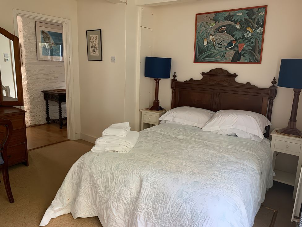 A bedroom with a bed and bedside tables at Lower Mill in Dittisham