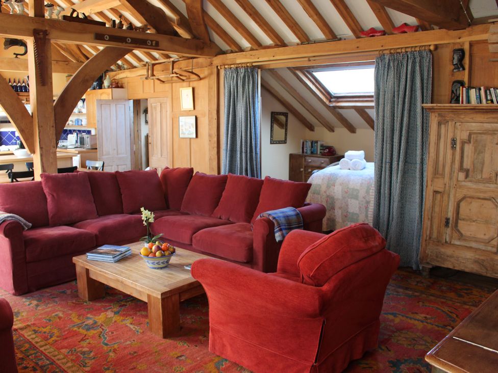 A living room with a sofa and coffee table at The Barn in Dittisham