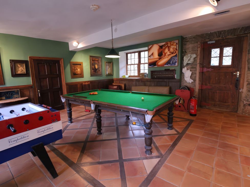 A games room with pool table and foosball table at Barberry Brook in Dittisham