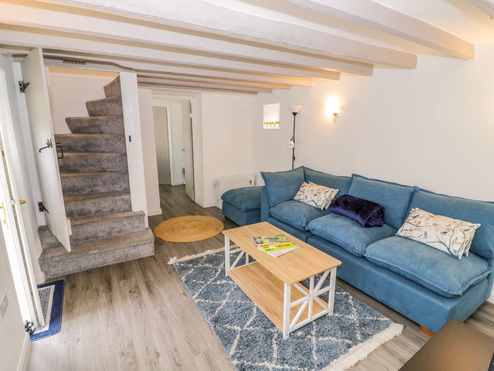 A living room with a sofa and coffee table at The Cottage in Ettington