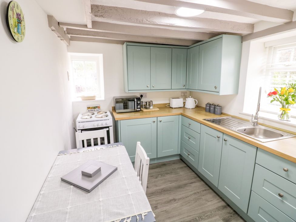 A kitchen with cabinets and appliances at The Cottage in Ettington