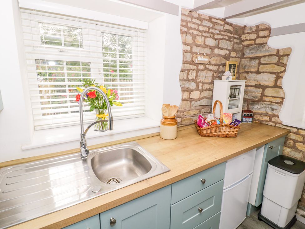 A kitchen with a sink and countertop at The Cottage in Ettington