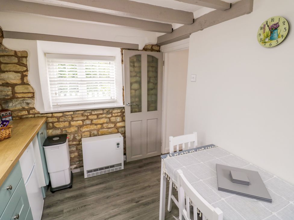 A kitchen with a table and chairs at The Cottage in Ettington