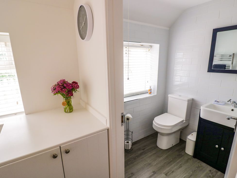 A bathroom with a toilet and a sink at The Cottage in Ettington
