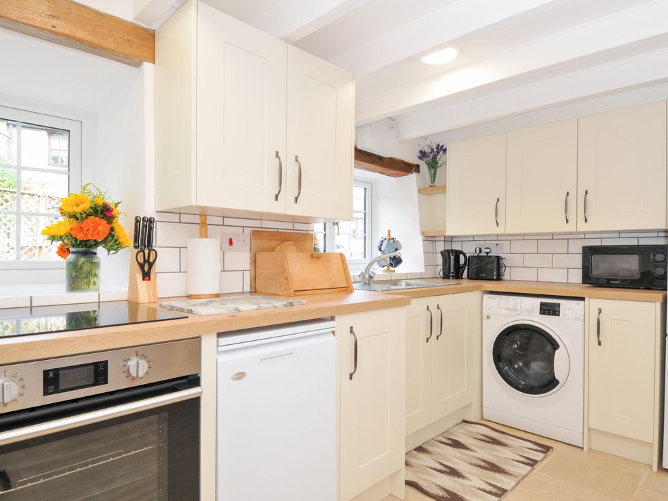 A kitchen with appliances and a flower vase at Henwood Barn near Upton Cross