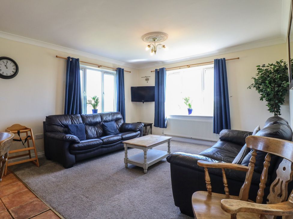 A living room with sofas and a coffee table at Tixall Manor Farm in Tixall near Great Haywood