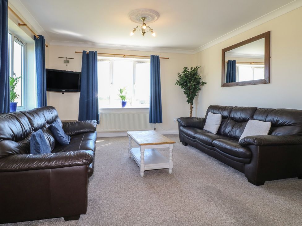 A living room with sofas and a coffee table at Tixall Manor Farm in Tixall near Great Haywood