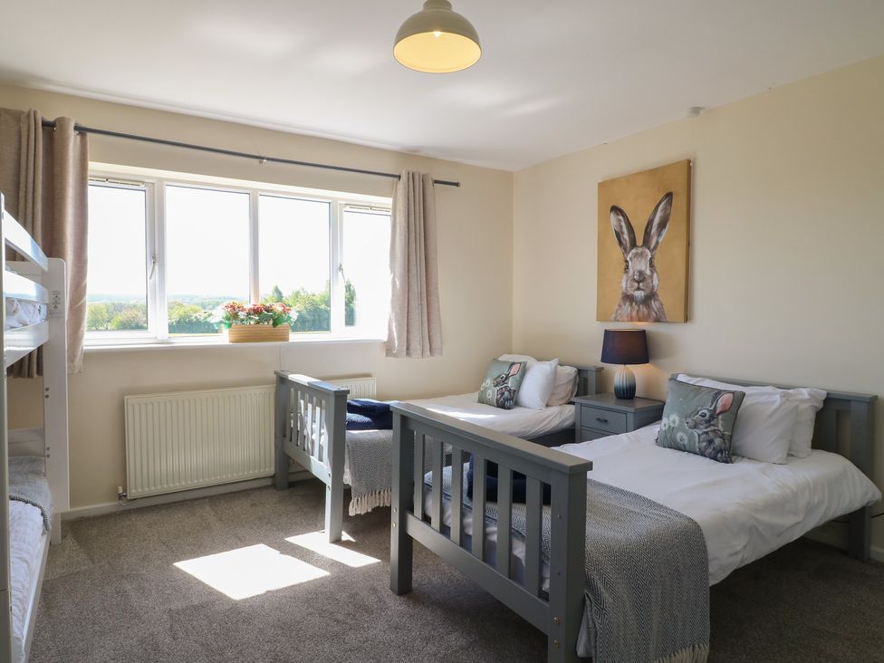 A bedroom with bunk bed and two single beds at Tixall Manor Farm in Tixall near Great Haywood