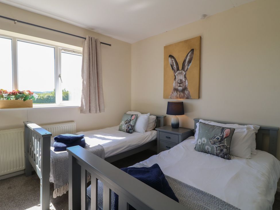 A bedroom with two single beds and a window at Tixall Manor Farm in Tixall near Great Haywood