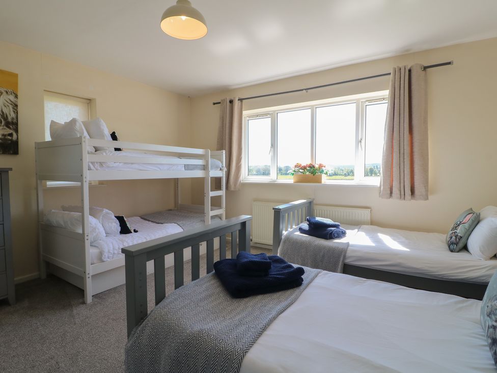 A bedroom with a bunk bed and a single bed at Tixall Manor Farm in Tixall near Great Haywood