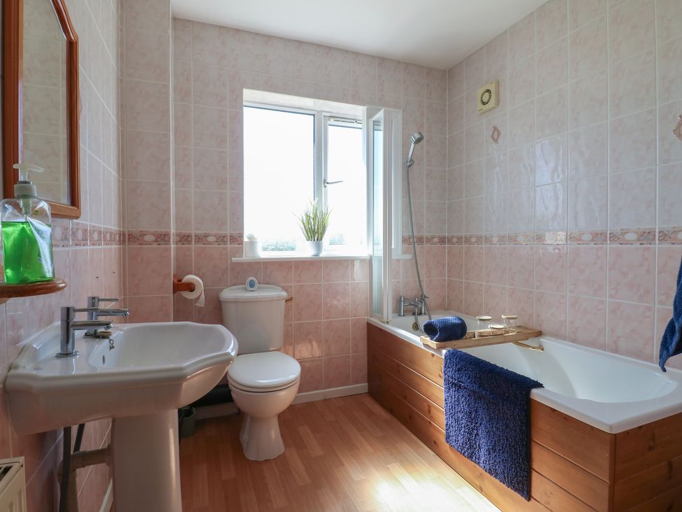 A bathroom with a bathtub and sink at Tixall Manor Farm in Tixall near Great Haywood