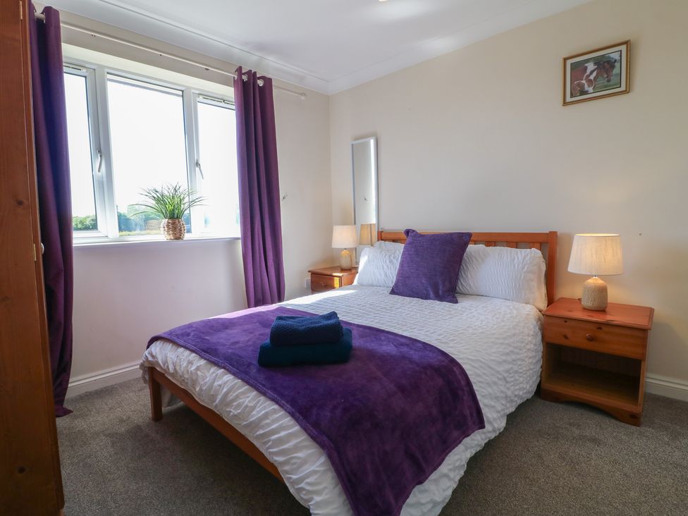 A bedroom with a bed and bedside tables at Tixall Manor Farm Tixall near Great Haywood