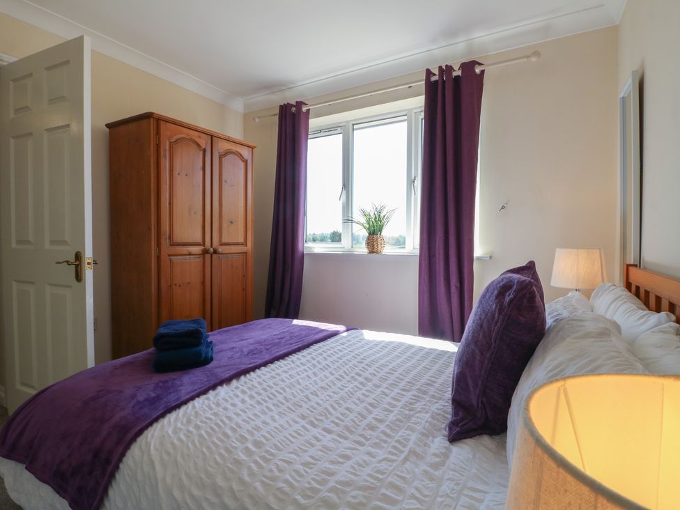 A bedroom with a bed and wardrobe at Tixall Manor Farm Tixall near Great Haywood