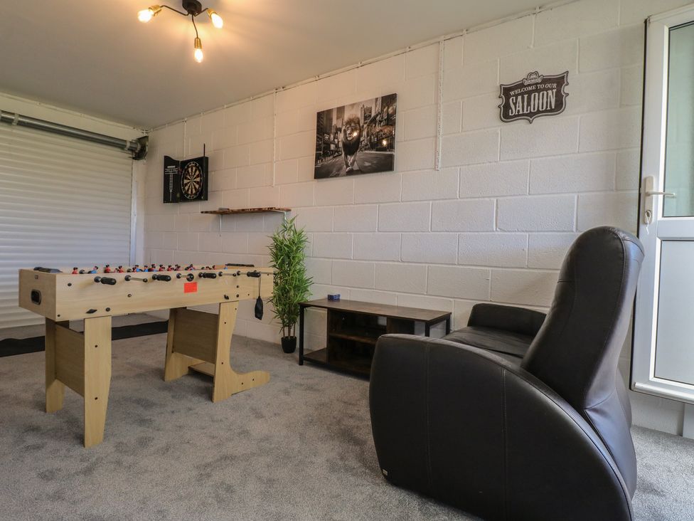A game room with a foosball table and dartboard at Tixall Manor Farm Tixall near Great Haywood
