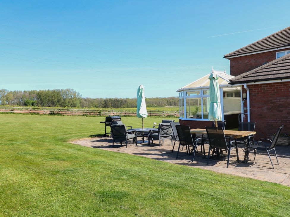 An outdoor patio area with a table and chairs at Tixall Manor Farm Tixall near Great Haywood