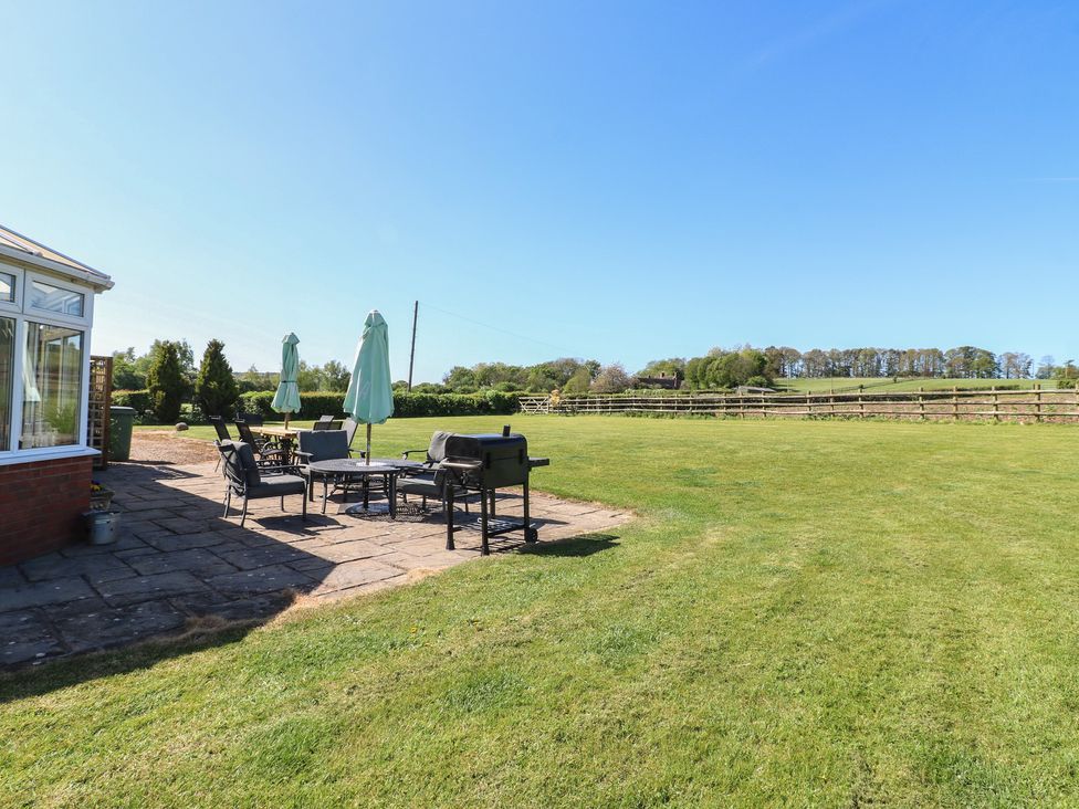 A garden with patio furniture and lawn at Tixall Manor Farm Tixall near Great Haywood