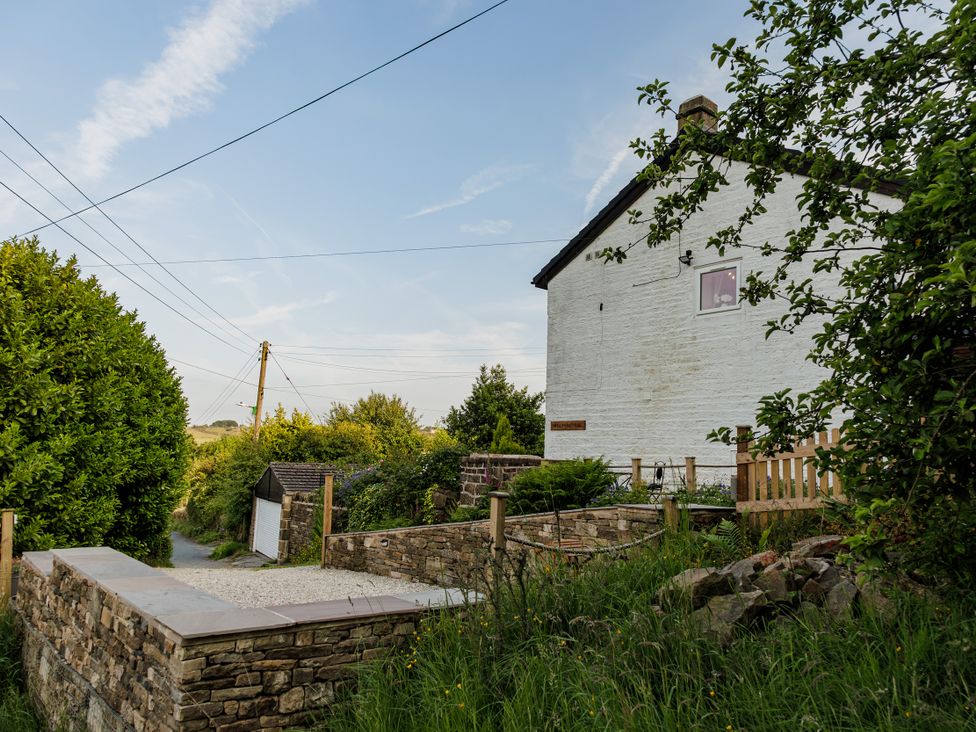 A house with a garden and pathway at Wells Cottage in Holmfirth