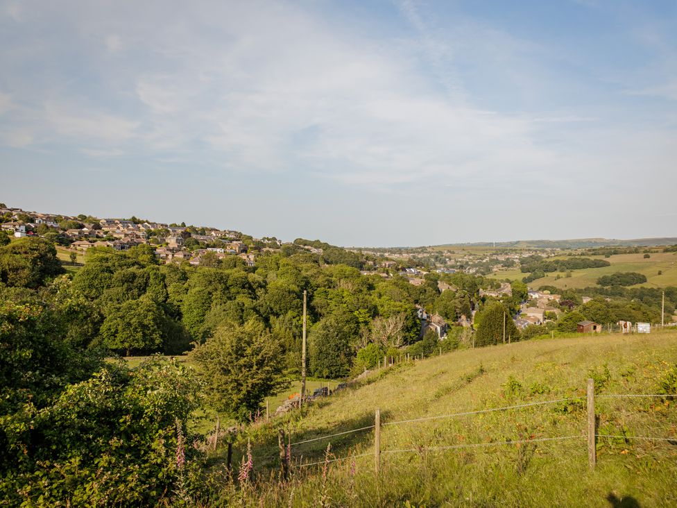 A landscape view of houses and trees at Wells Cottage in Holmfirth