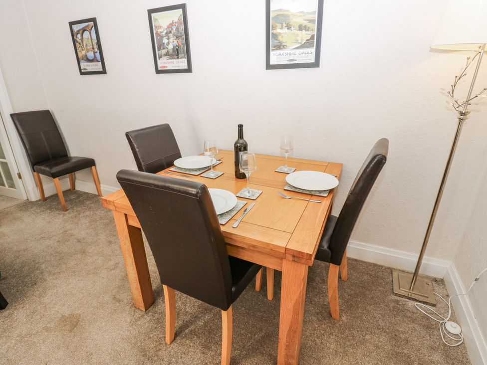 A dining room with a wooden table and chairs at Joyces Cottage, 2 Brown Hill in Low Row near Reeth