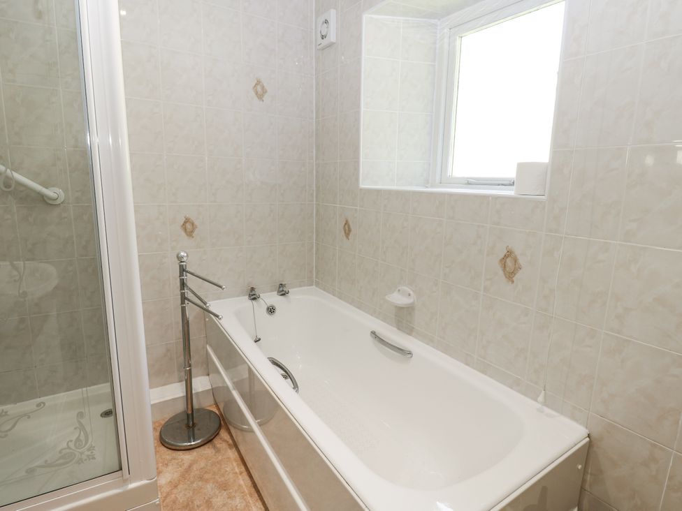 A bathroom with a bathtub and shower at Joyces Cottage, 2 Brown Hill in Low Row near Reeth