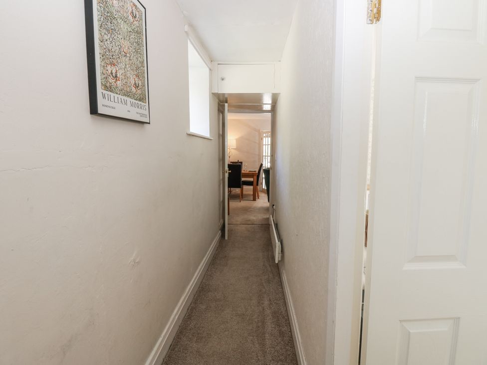A hallway with a picture frame on the wall at Joyces Cottage, 2 Brown Hill Low Row near Reeth
