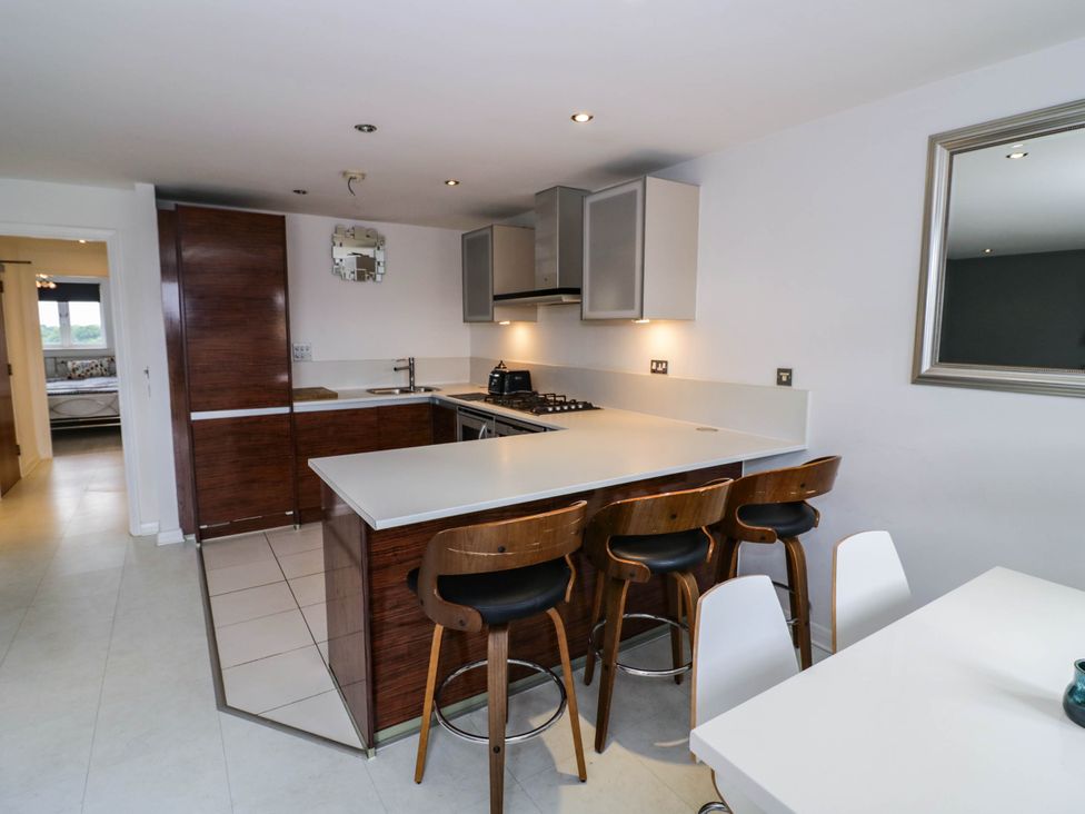 A kitchen with stools and cabinetry at 63 Vista Heights Solihull