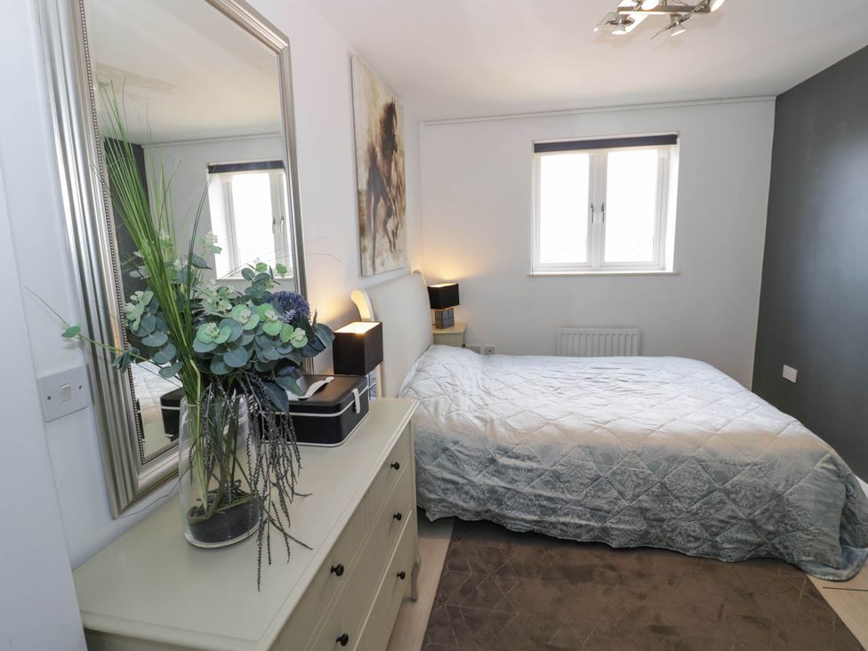 A bedroom with a bed and dresser at 63 Vista Heights in Solihull