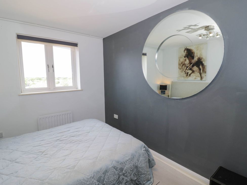A bedroom with a bed and window at 63 Vista Heights in Solihull