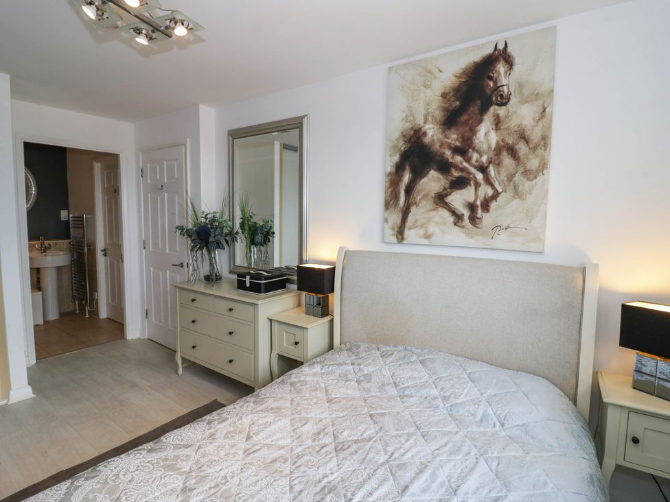 A bedroom with a bed and artwork at 63 Vista Heights in Solihull