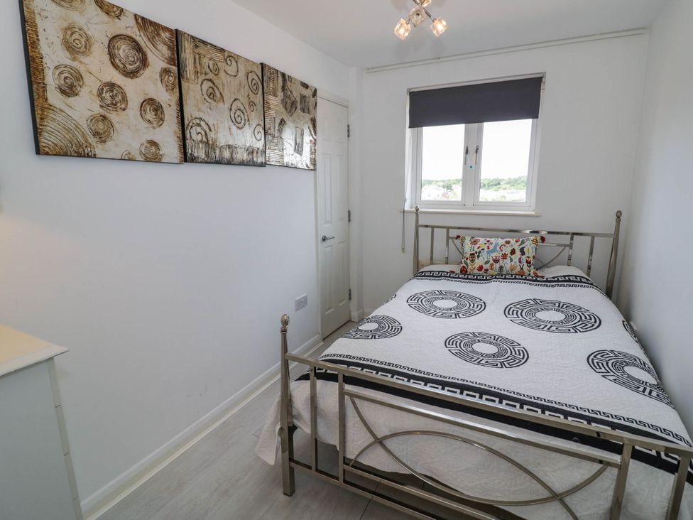 A bedroom with a bed and artwork at 63 Vista Heights in Solihull