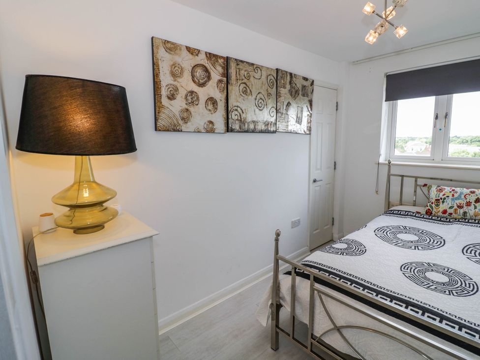 A bedroom with a bed and lamp at 63 Vista Heights in Solihull