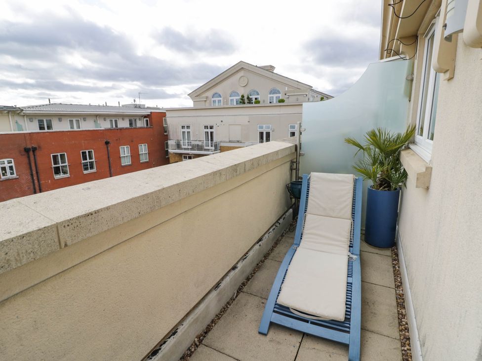 A balcony with a deck chair and potted plant at 63 Vista Heights Solihull