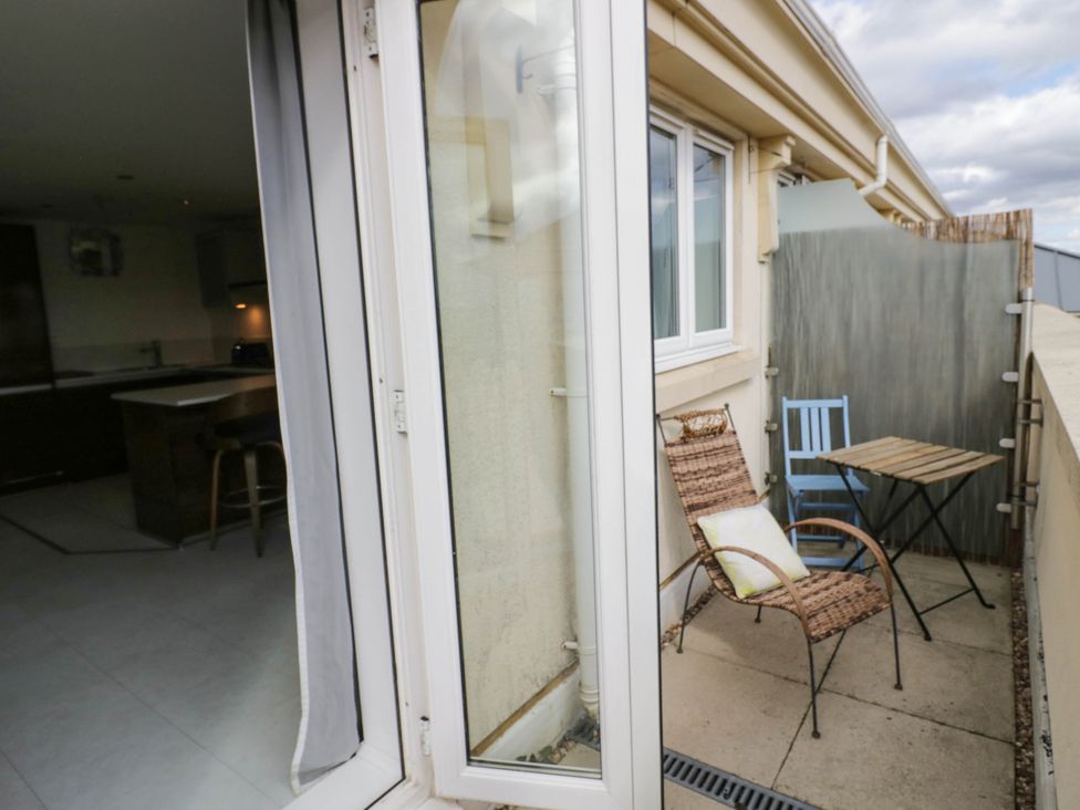 A balcony with two chairs and a table at 63 Vista Heights Solihull