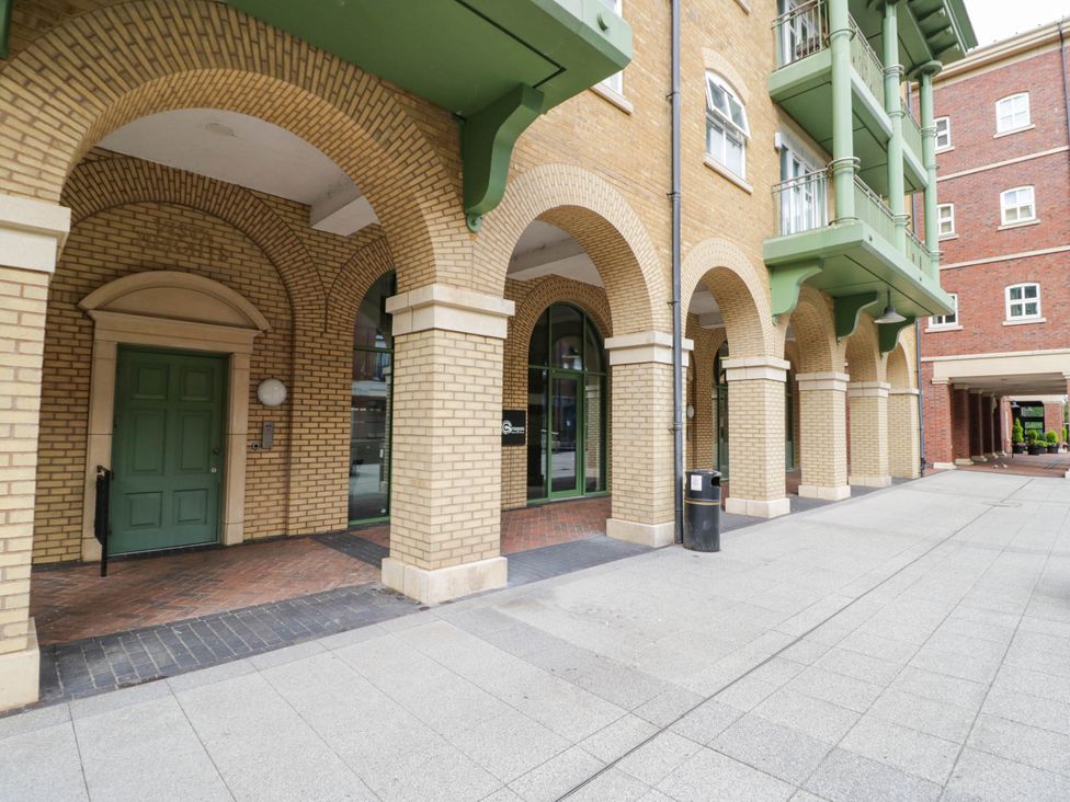 An outdoor area with arches and a green door at 63 Vista Heights Solihull