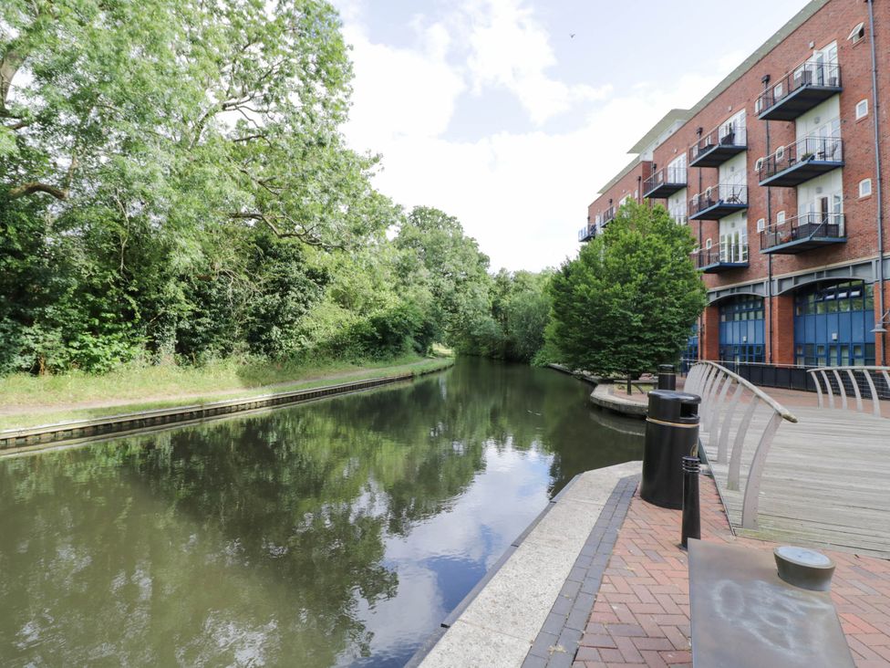 A canal with trees and buildings at 63 Vista Heights in Solihull