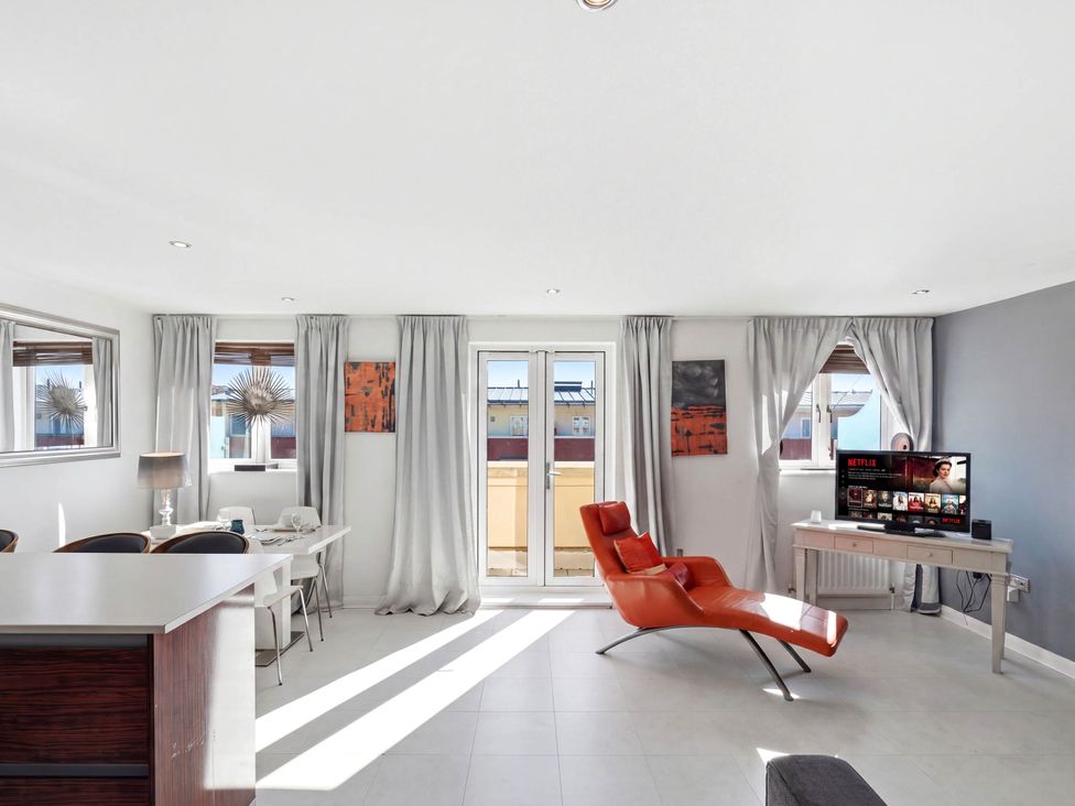 A living room with a television and seating area at 63 Vista Heights in Solihull