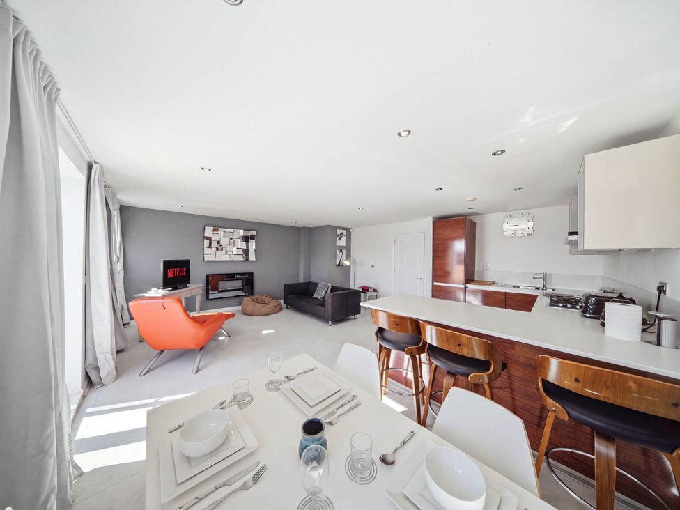 A living room with a dining area and kitchen features at 63 Vista Heights in Solihull
