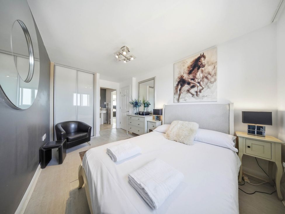 A bedroom with a bed, chair, and dresser at 63 Vista Heights in Solihull