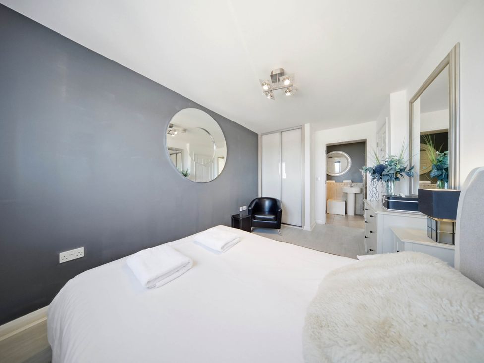 A bedroom with a bed and a chair at 63 Vista Heights, Solihull
