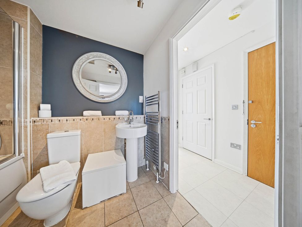 A bathroom with toilet, sink, shower, and towel radiator at 63 Vista Heights in Solihull