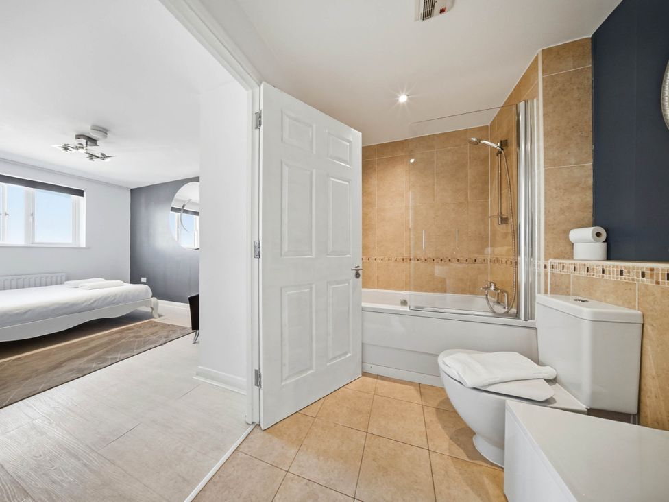 A bathroom with a bathtub and shower at 63 Vista Heights in Solihull