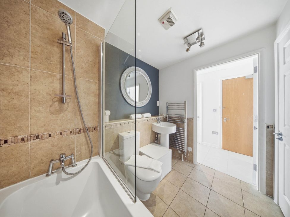 A bathroom with a shower, bathtub, toilet, and sink at 63 Vista Heights in Solihull